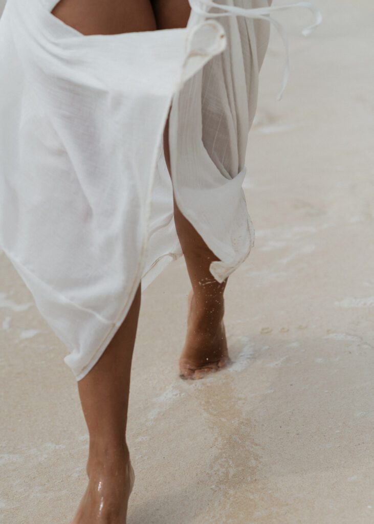 bride running on the beach during elopement