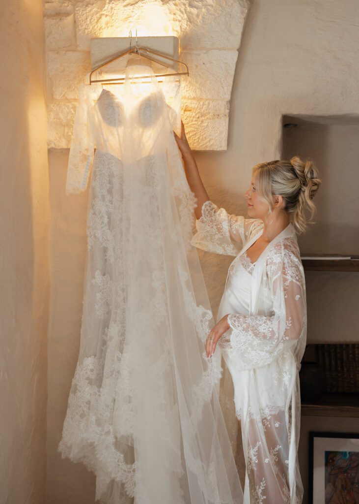 bride holding up her wedding dress in italian venue